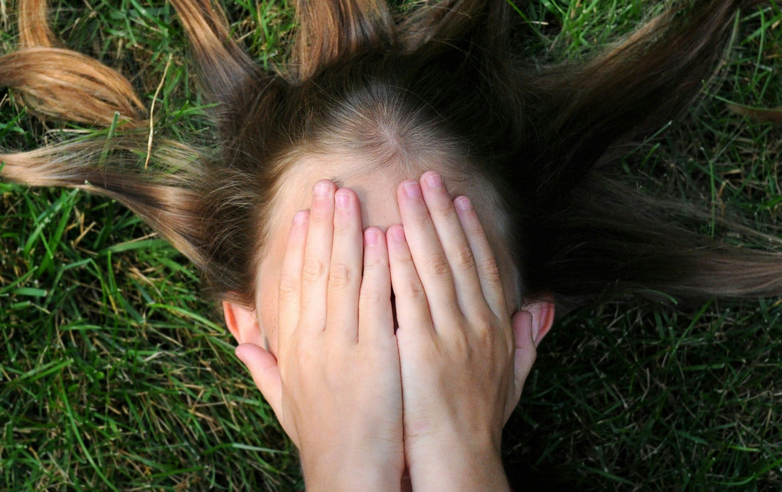 Anxiety child covering her face