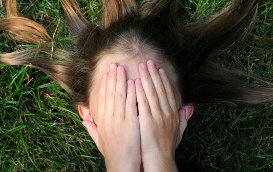 Anxiety child covering her face