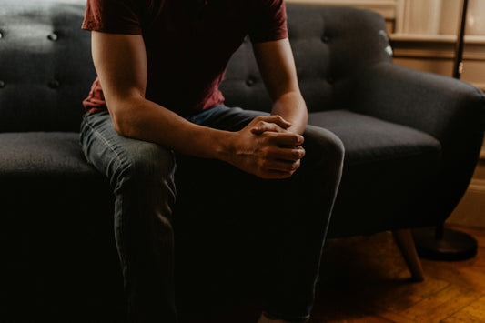 A person sitting in a peaceful space, discussing CBT worksheets to practice positive mental health habits.